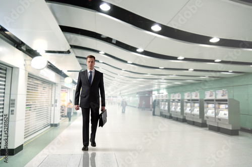 Photo: business man walking in subway business man walking in subway