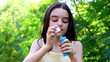 Teenager blowing colorful bubbles soap