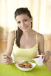Young happy woman eating italian pasta
