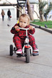baby on her  tricycle