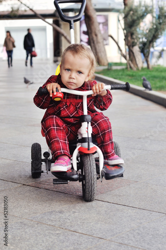 Photo: baby on her tricycle baby on her tricycle