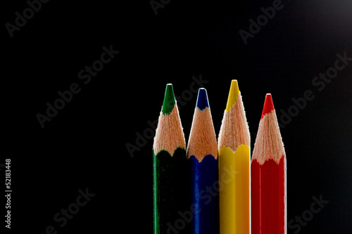 Photo: Four primary color pencils before black background Four primary color pencils before black background
