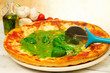 pizza with pesto sauce and ingredients