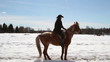 Girl cowboy on a horse - a step backwards