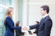 Business people shaking hands, finishing up a meeting at the off