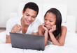 Couple Looking At The Laptop