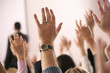 Business lecture with hands in the air