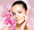 woman applying cosmetic cream  on face