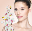 Adult woman with beautiful face and flowers