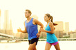 City running couple jogging outside