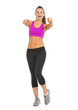 Happy fitness young woman pointing in camera