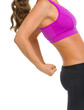 Closeup on fitness young woman showing biceps
