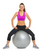 Portrait of smiling fitness young woman on fitness ball