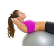 Fitness young woman doing abdominal crunch on fitness ball