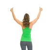 Fitness woman rejoicing success . rear view