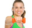 Closeup on happy fitness woman making exercise with dumbbells