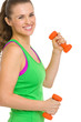 Portrait of smiling fitness young woman with dumbbells
