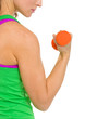 Closeup on fitness woman making exercise with dumbbells