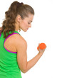 Fitness young woman making exercise with dumbbells