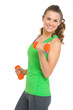 Happy fitness young woman with dumbbells