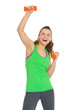 Smiling healthy young woman making exercise with dumbbells