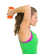 Fitness young woman making exercise with dumbbells