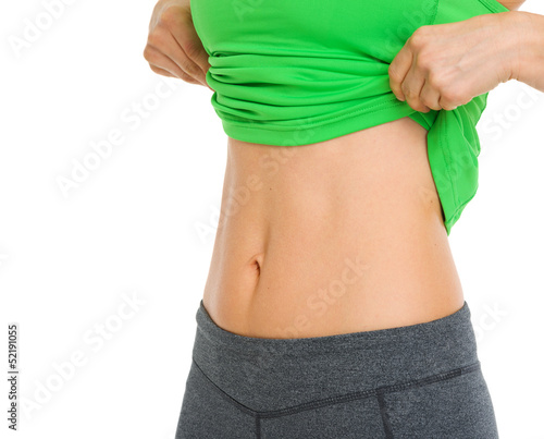 Photo: Closeup on tummy of fitness woman Closeup on tummy of fitness woman