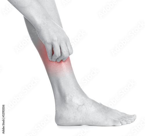 Photo: Women scratch itchy leg with hand. Women scratch itchy leg with hand.