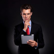 business man with tablet thinking
