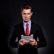 business man holds tablet