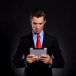 business man looks at tablet