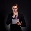 business man with pad, thinking