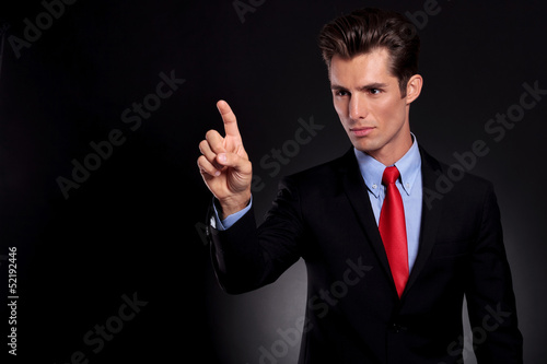 Photo: business man touches fictive screen business man touches fictive screen