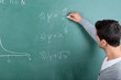Photo: lehrer schreibt eine formel an die tafel lehrer schreibt eine formel an die tafel