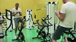 Man using smartphone during training on exercise bicycle