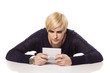 blonde with short hair to concentrate on her mini game computer