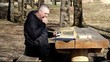 Tired man reading a book outdoors