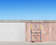 Scaffold next to the wall. Refurbishment