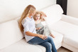 Mother and daughter wiht tablet at sofa