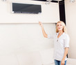 Female holding a remote control air conditioner