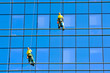 Washers wash the windows of modern skyscraper