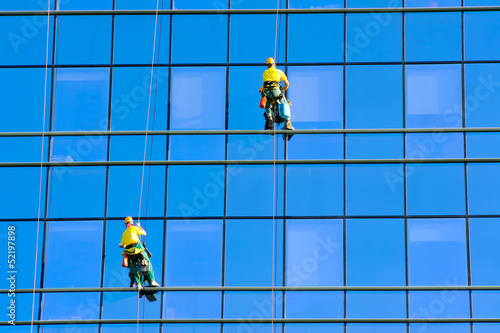 Photo: Washers wash the windows of modern skyscraper Washers wash the windows of modern skyscraper