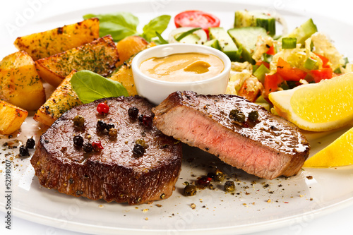 Photo: Grilled steak, baked potatoes and vegetables Grilled steak, baked potatoes and vegetables