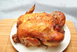Whole Roasted Chicken on a White Serving Plate