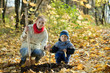 woman and boy  planting  tree in autumn