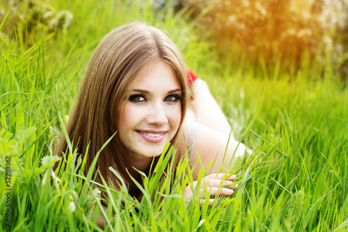 Photo: beautiful girl lying down of grass beautiful girl lying down of grass