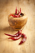 Red hot dry chili peppers over wooden background