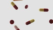 Undershot angle of pills being thrown onto transparent surface