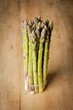 Bunch of fresh green asparagus on wooden background