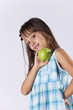 Little girl showing a green apple